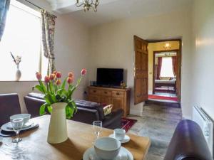 a living room with a table and a couch at Walcot Farm in North Lydbury