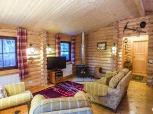 ein Wohnzimmer mit Sofas und einem Flachbild-TV in der Unterkunft Wilderness Lodge in Shelve