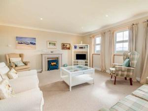 a living room with a couch and a fireplace at Little Laight in Cairnryan