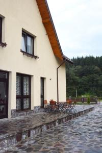 a group of chairs sitting outside of a building at Cabana Plapumioara in Crucea