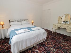 a bedroom with a bed with two towels on it at Granville Lodge in Great Givendale