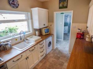 a kitchen with a sink and a microwave at 31 Elmville Avenue in Scarborough