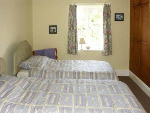 a bedroom with a bed and a window at Pabo Lodge in Llandudno Junction