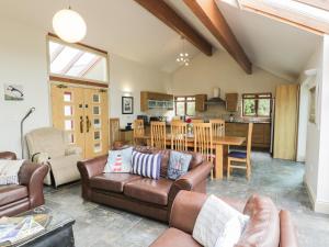 a living room with a couch and a table at Manaros Cottage in Aberdaron