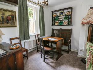 a dining room with a table and chairs and a window at Sally's Cottage in Carleton
