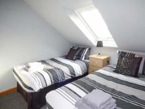 a bedroom with two beds and a window at Fortunatus in Whitby