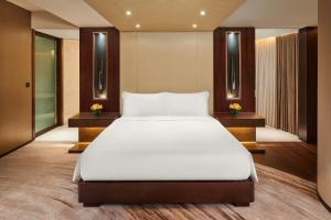 Un pat sau paturi într-o cameră la Altira Macau