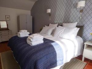a bedroom with a bed with towels on it at Goosepond in Wistanstow