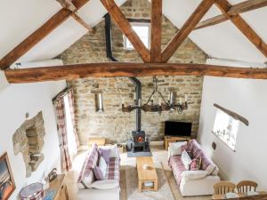 an attic living room with exposed beams at Cottage Val in Fylingdales