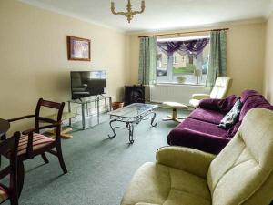 a living room with a couch and a table at Goldings in Wells