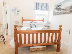 a bedroom with a wooden bed in a room at Oak Lodge in Cromer