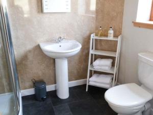 a bathroom with a sink and a toilet and a shower at Skipaflotta in Rhiconich +15 photos