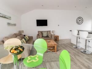 a living room with a couch and a table at 3 Marina View in Pwllheli