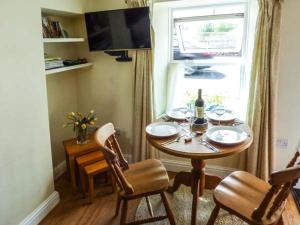 a dining room with a table and a window at Fells Cottage in Sedbergh