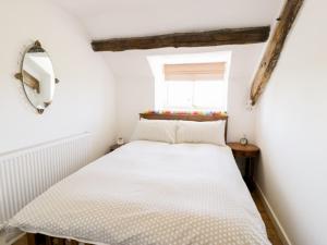 a bedroom with a bed in a room with a window at 2 Borthwen Cottages in Dyffryn
