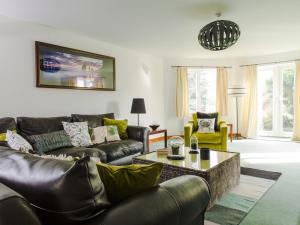 a living room with a couch and a table at Nairn in Braunton