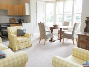 a living room with a table and chairs at Housekeeper's Rooms in Pathhead