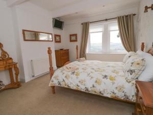 1 dormitorio con cama y ventana en Upper Highlees Farm, en Luddenden Foot