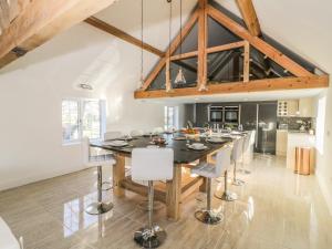 a kitchen with a large wooden table and chairs at Lower Tundridge Cottage in Suckley