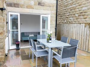a white table and chairs on a patio at Chine Cottage in Sandsend