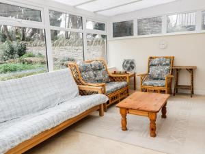 a living room with a couch and two chairs at Broadway Lands Farm in Little Dewchurch