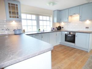 a kitchen with white cabinets and a counter top at The 'Stables' in Waterfall