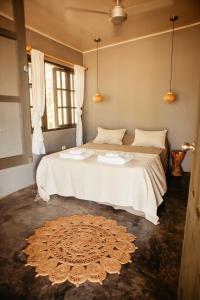 a bedroom with a large bed with a rug on the floor at Casa Morrillo in Morrillo