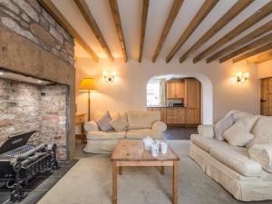 a living room with two couches and a fireplace at Fisherman's Cottage in Seahouses