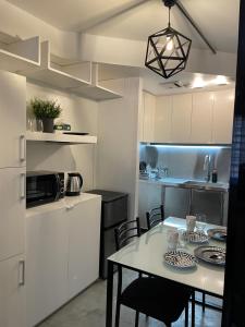 a kitchen with a table and chairs in a room at CRIB 253 Subic Bay in Olongapo