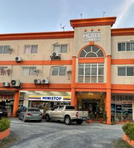 a hotel with cars parked in front of a building at CRIB 253 Subic Bay in Olongapo
