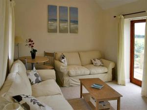 a living room with a couch and a table at Lodge Cottage in York