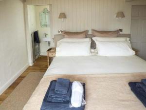 a bedroom with a large white bed with a blue tray on it at The Den in Carmarthen
