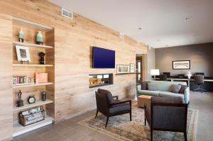 a living room with a couch and a fireplace at Country Inn & Suites by Radisson, Springfield Southeast in Springfield