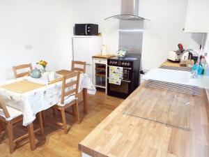 a kitchen with a table and a dining room at Kate's Cottage in Bourton on the Water