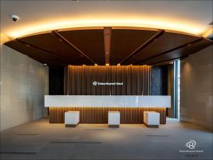 a lobby with a counter and chairs in a building at Daiwa Roynet Hotel Yamagata Ekimae in Yamagata