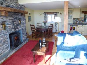 a living room with a couch and a fireplace at Pheasant Cottage in Grange Over Sands