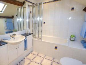 a bathroom with a sink and a tub and a toilet at Pheasant Cottage in Grange Over Sands +7 photos