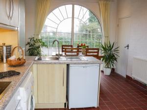 a kitchen with a sink and a large window at Rose Villa in Llanymynech