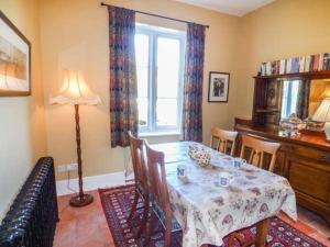 a dining room with a table and a window at The Gate House in Oakamoor