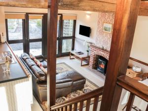 a living room with a couch and a fireplace at The Granary in Bucknell