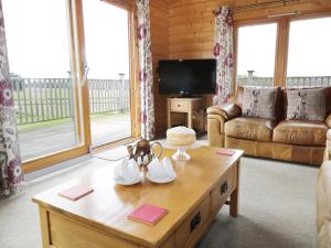 a living room with a couch and a coffee table at Look Out Lodge in Little Witley