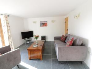 a living room with a couch and a table at Lower West Curry Cottage in Launceston