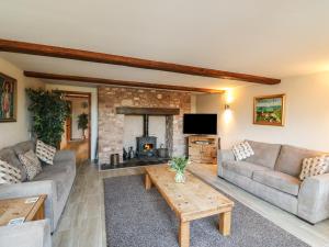 a living room with a couch and a fireplace at The Linhay in Watchet