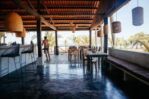 a man standing in a restaurant with tables and chairs at Casa Morrillo in Morrillo