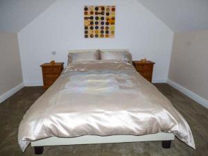 a bedroom with a large bed with two night stands at Flat 3 in Bridlington