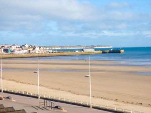 a view of a beach with buildings and the ocean at Flat 3 in Bridlington +1 photo