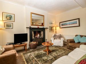a living room with a couch and a fireplace at The Coach House in Abergavenny