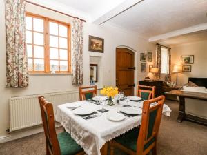 a dining room with a table with a white table cloth at The Coach House in Abergavenny