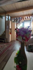 a vase filled with flowers sitting on a table at Guesthouse Dobr Bobr in Krasnoyarsk