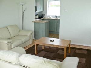 a living room with a couch and a coffee table at Seascape in Lowestoft